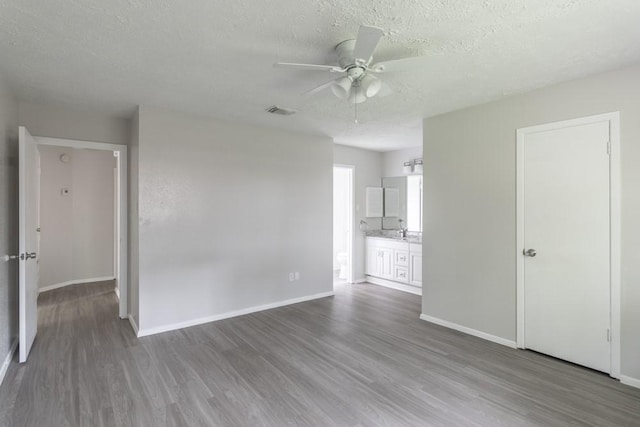 15803 Cerca Blanca Dr, Houston, TX 77083 - empty room with ceiling fan, wood finished floors, and a textured ceiling