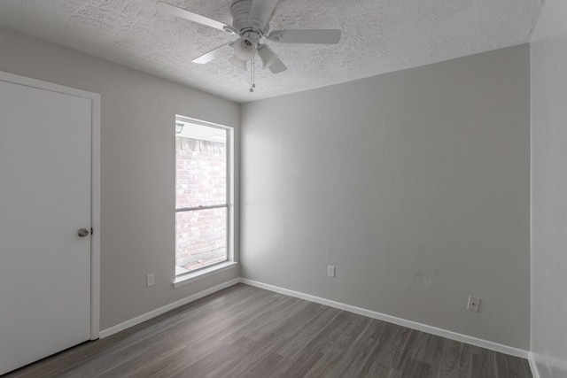 15803 Cerca Blanca Dr, Houston, TX 77083 - spare room with dark wood-style flooring, a textured ceiling, and a ceiling fan