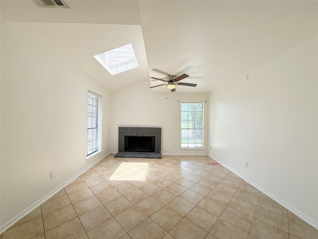 10912 Gulf Fwy Unit 68, Houston, TX 77034 - unfurnished living room with a skylight, a fireplace, a ceiling fan, light tile patterned flooring, and vaulted ceiling