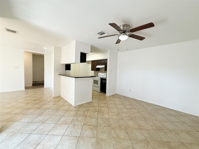 10912 Gulf Fwy Unit 68, Houston, TX 77034 - kitchen with white electric range oven, under cabinet range hood, dark countertops, ceiling fan, and open floor plan