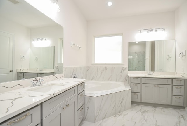6514 Fraser Point Ct, Spring, TX 77379 - bathroom featuring a bath, two vanities, marble finish flooring, a marble finish shower, and recessed lighting