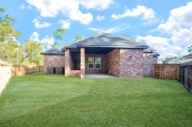 6514 Fraser Point Ct, Spring, TX 77379 - back of property with brick siding, roof with shingles, a patio, and a fenced backyard