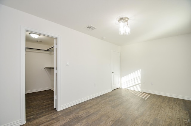 6514 Fraser Point Ct, Spring, TX 77379 - unfurnished bedroom featuring wood finished floors, a walk in closet, and a closet