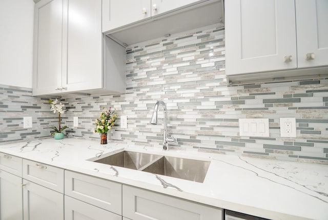 6514 Fraser Point Ct, Spring, TX 77379 - kitchen with tasteful backsplash, light stone countertops, and white cabinets