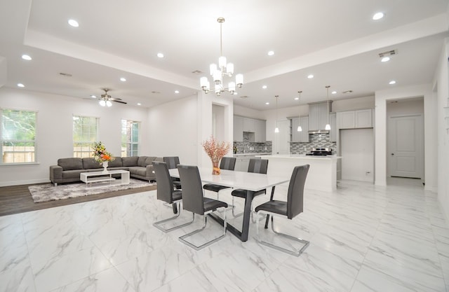 6514 Fraser Point Ct, Spring, TX 77379 - dining space with light marble finish floors, recessed lighting, a tray ceiling, a chandelier, and a ceiling fan