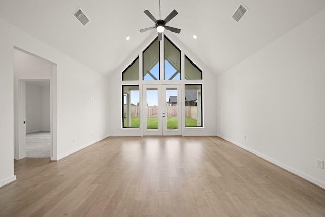 11435 Desert Orangetip Way, Cypress, TX 77433 - unfurnished living room featuring a ceiling fan, light wood-style flooring, and high vaulted ceiling