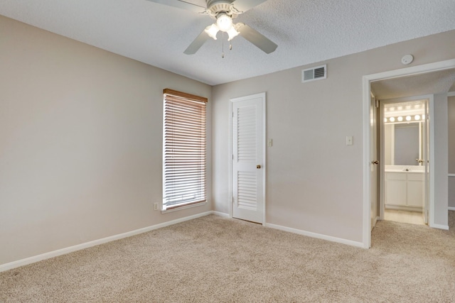 12550 Whittington Dr Unit 610, Houston, TX 77077 - unfurnished bedroom featuring light colored carpet, a closet, a ceiling fan, and a textured ceiling
