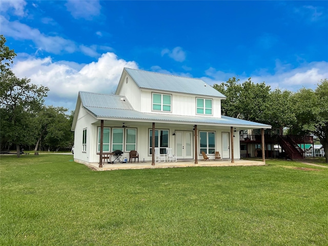 2263 Lcr 740, Thornton, TX 76687 - rear view of property with board and batten siding, a patio, a lawn, and a metal roof