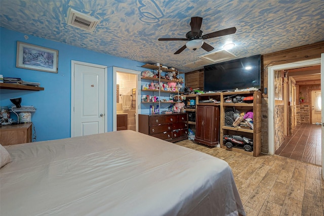 6009 Crane St, Houston, TX 77026 - bedroom featuring wood finished floors, ensuite bath, and ceiling fan