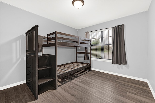 9002 Saint Laurent Ln, Houston, TX 77044 - unfurnished bedroom with baseboards and wood finished floors