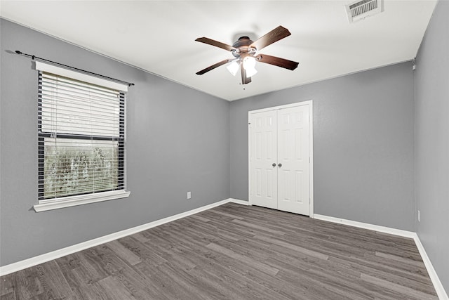 9002 Saint Laurent Ln, Houston, TX 77044 - unfurnished bedroom featuring wood finished floors, a closet, and a ceiling fan