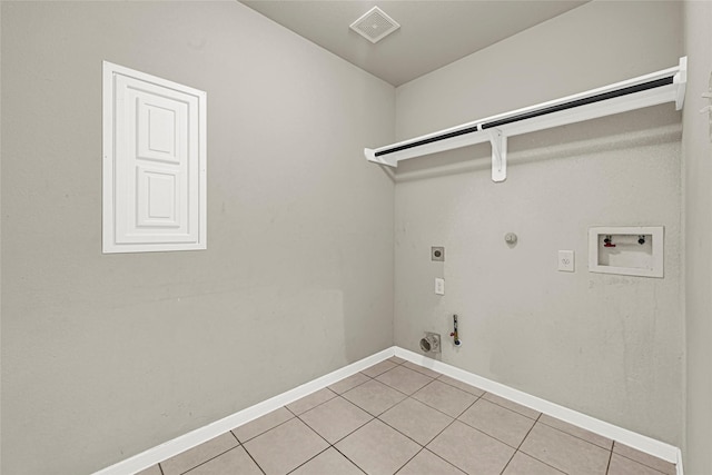 9002 Saint Laurent Ln, Houston, TX 77044 - laundry area with hookup for a gas dryer, hookup for a washing machine, light tile patterned floors, and electric dryer hookup
