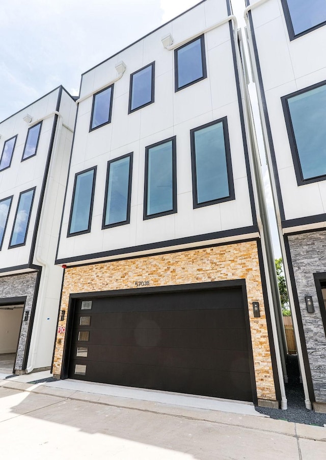 5703 Dolores St Unit A, Houston, TX 77057 - view of front facade with a garage and stone siding