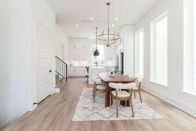 5703 Dolores St Unit A, Houston, TX 77057 - dining area featuring stairway, light wood-style flooring, a chandelier, and recessed lighting
