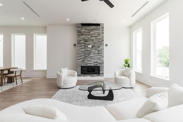 5703 Dolores St Unit A, Houston, TX 77057 - living area featuring wood finished floors, a tile fireplace, a ceiling fan, and recessed lighting