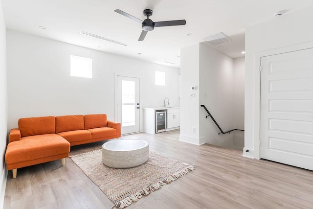 5703 Dolores St Unit A, Houston, TX 77057 - living room featuring wine cooler, plenty of natural light, light wood-style flooring, and ceiling fan