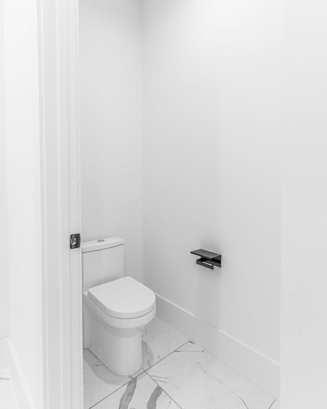 5703 Dolores St Unit A, Houston, TX 77057 - bathroom featuring marble look tile flooring and toilet
