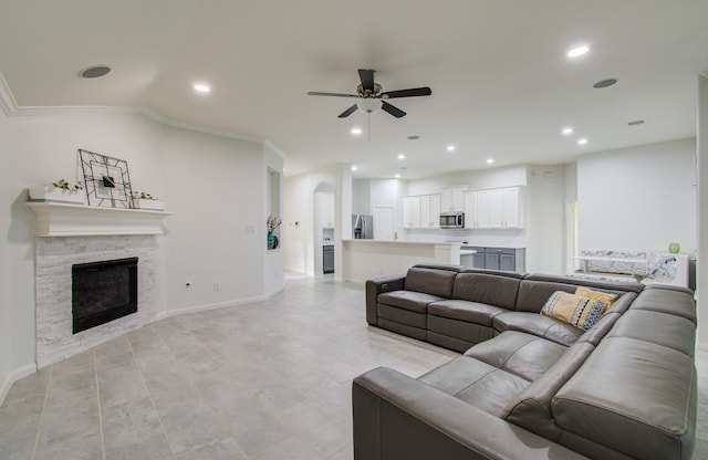 4639 Regal Shadow Ln, Sugar Land, TX 77479 - living area with a ceiling fan, recessed lighting, crown molding, and a stone fireplace