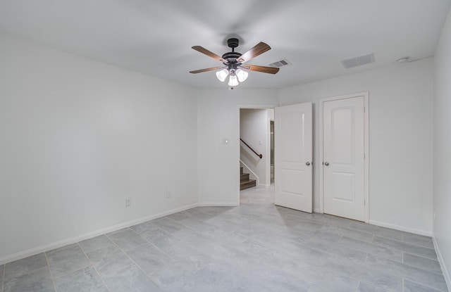 4639 Regal Shadow Ln, Sugar Land, TX 77479 - spare room featuring ceiling fan, stairway, and light tile patterned floors
