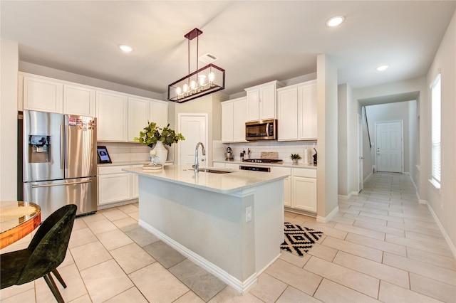 17715 White Lightning Way, Spring, TX 77379 - kitchen with appliances with stainless steel finishes, tasteful backsplash, light tile patterned floors, white cabinets, and recessed lighting