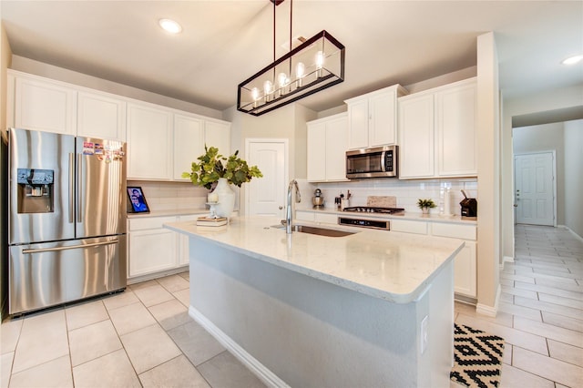17715 White Lightning Way, Spring, TX 77379 - kitchen featuring stainless steel appliances, decorative backsplash, light tile patterned floors, white cabinets, and recessed lighting
