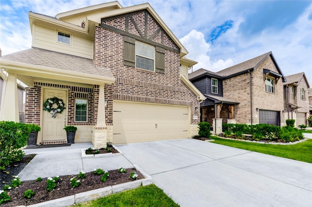 17715 White Lightning Way, Spring, TX 77379 - view of front facade with a garage, driveway, brick siding, stone siding, and a shingled roof