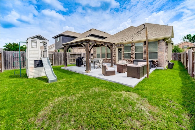 17715 White Lightning Way, Spring, TX 77379 - rear view of house with a gazebo, brick siding, a fenced backyard, a shingled roof, and a patio