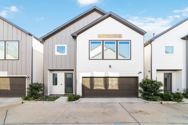 240 Julia St Unit D, Houston, TX 77022 - view of front of house with board and batten siding, driveway, and a garage