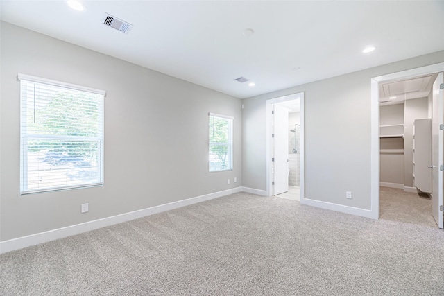 240 Julia St Unit D, Houston, TX 77022 - unfurnished bedroom featuring attic access, a spacious closet, light carpet, recessed lighting, and a closet