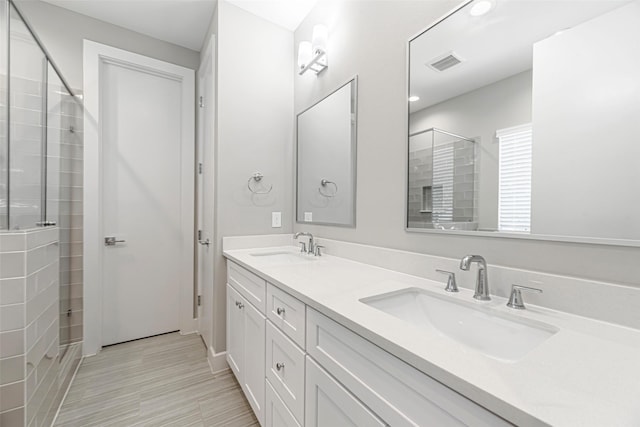 240 Julia St Unit D, Houston, TX 77022 - bathroom with double vanity, a tile shower, and recessed lighting
