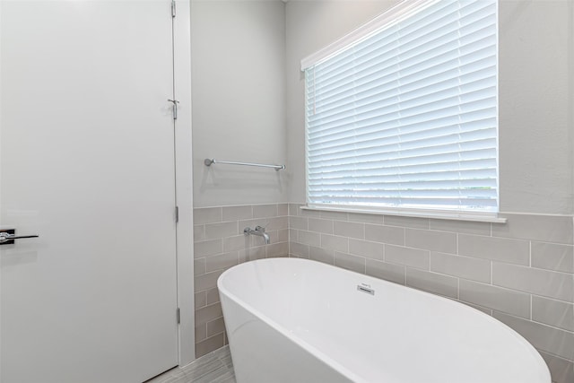 240 Julia St Unit D, Houston, TX 77022 - full bath featuring tile walls and a freestanding tub