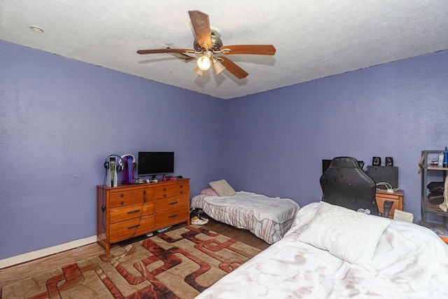 117 Pecan Dr, Baytown, TX 77520 - bedroom featuring wood finished floors, ceiling fan, and an office area