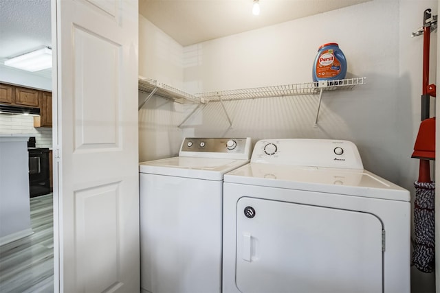 2300 Old Spanish Trl Unit 1060, Houston, TX 77054 - laundry room with separate washer and dryer and light wood finished floors