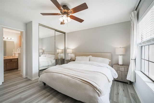 2300 Old Spanish Trl Unit 1060, Houston, TX 77054 - bedroom featuring light wood-style flooring, a closet, and a ceiling fan