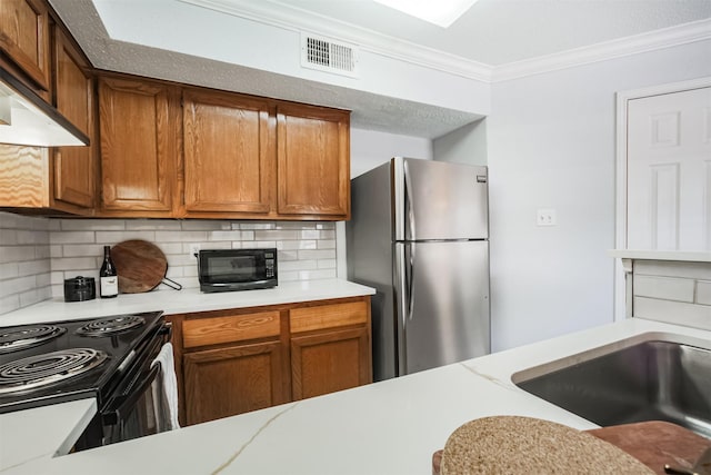 2300 Old Spanish Trl Unit 1060, Houston, TX 77054 - kitchen featuring black appliances, crown molding, exhaust hood, light countertops, and decorative backsplash