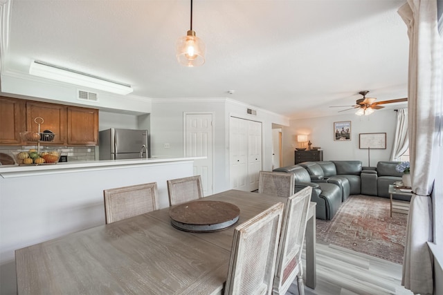 2300 Old Spanish Trl Unit 1060, Houston, TX 77054 - dining room featuring crown molding, ceiling fan, and light wood-type flooring