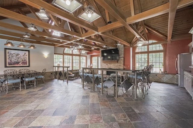 2300 Old Spanish Trl Unit 1060, Houston, TX 77054 - dining area featuring stone tile floors, beamed ceiling, and high vaulted ceiling