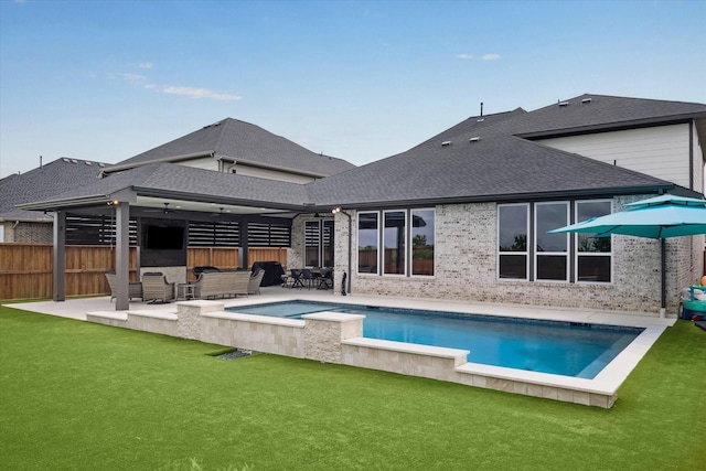 14115 Garibaldi Dr, Cypress, TX 77433 - back of property featuring a patio area, a shingled roof, an outdoor pool, and brick siding