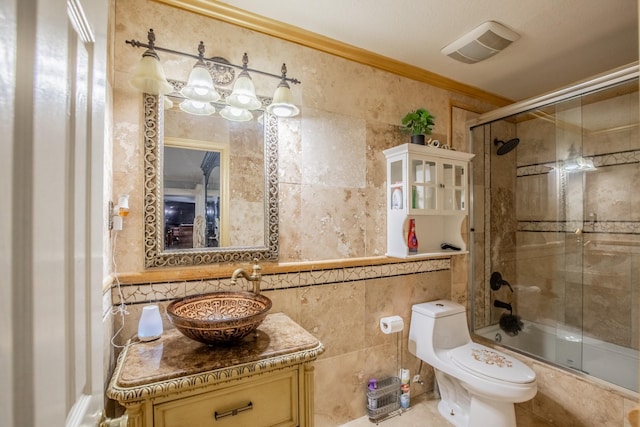 2019 Vanamen Ct, Conroe, TX 77304 - bathroom with tile walls, vanity, enclosed tub / shower combo, and crown molding