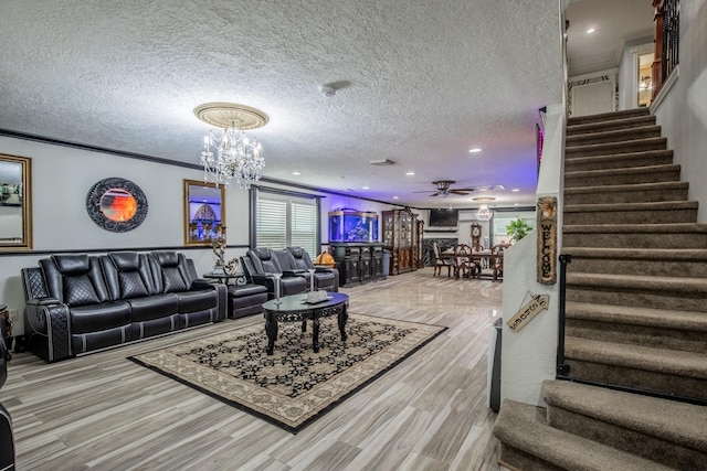 2019 Vanamen Ct, Conroe, TX 77304 - living area featuring stairway, a textured ceiling, a chandelier, wood finished floors, and ceiling fan