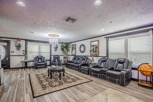 2019 Vanamen Ct, Conroe, TX 77304 - living room with ornamental molding, a textured ceiling, a chandelier, and wood finished floors