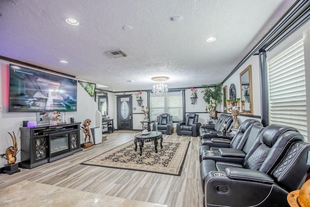 2019 Vanamen Ct, Conroe, TX 77304 - living area with a textured ceiling, a chandelier, wood finished floors, and recessed lighting