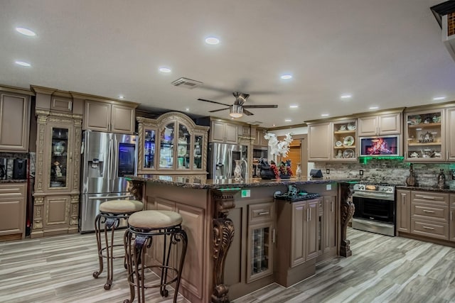 2019 Vanamen Ct, Conroe, TX 77304 - kitchen featuring appliances with stainless steel finishes, open shelves, a breakfast bar area, ceiling fan, and backsplash