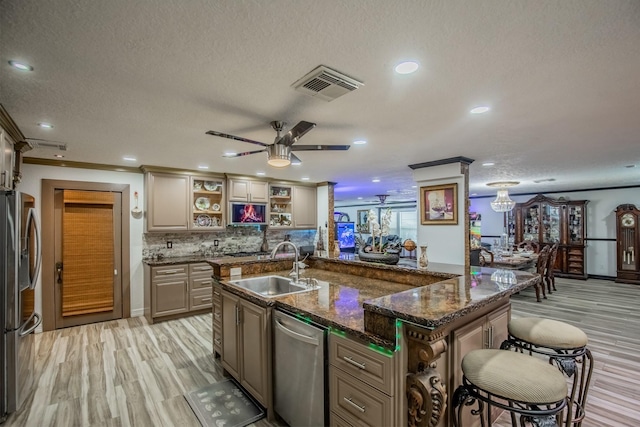 2019 Vanamen Ct, Conroe, TX 77304 - kitchen with stainless steel appliances, open shelves, a kitchen breakfast bar, ceiling fan, and a textured ceiling