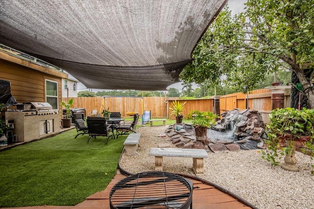 2019 Vanamen Ct, Conroe, TX 77304 - fenced backyard with outdoor dining space, area for grilling, and a patio area