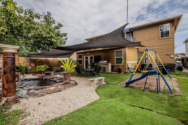 2019 Vanamen Ct, Conroe, TX 77304 - rear view of property featuring a patio and an outdoor kitchen
