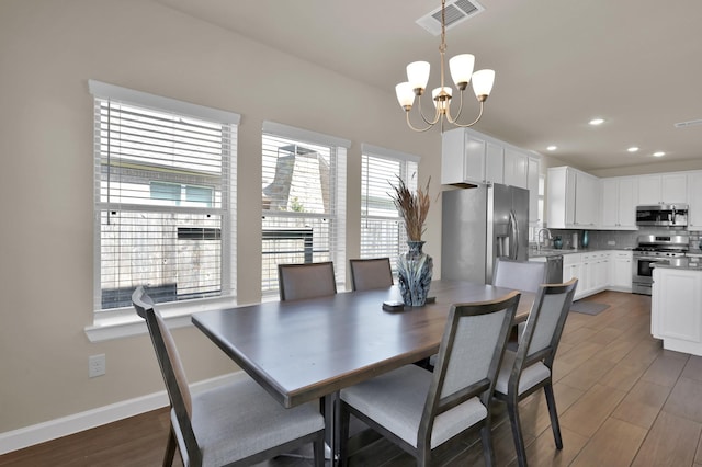 3604 Magnolia Crest Ln, Spring, TX 77386 - dining room with a chandelier, wood finished floors, and recessed lighting