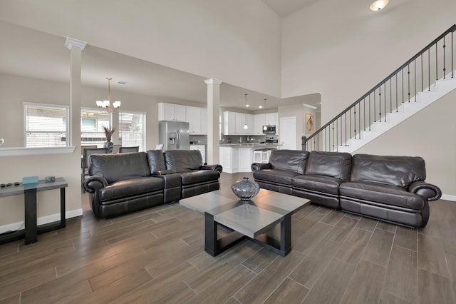 3604 Magnolia Crest Ln, Spring, TX 77386 - living area with decorative columns, dark wood-style floors, a chandelier, and stairway