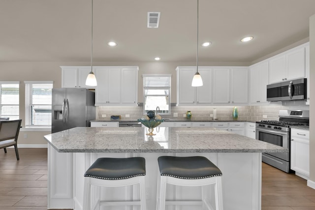 3604 Magnolia Crest Ln, Spring, TX 77386 - kitchen with stainless steel appliances, a kitchen island, backsplash, healthy amount of natural light, and recessed lighting