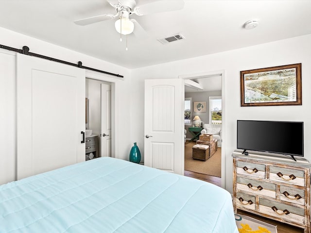 4039 San Jacinto Dr, Galveston, TX 77554 - bedroom featuring a barn door and ceiling fan